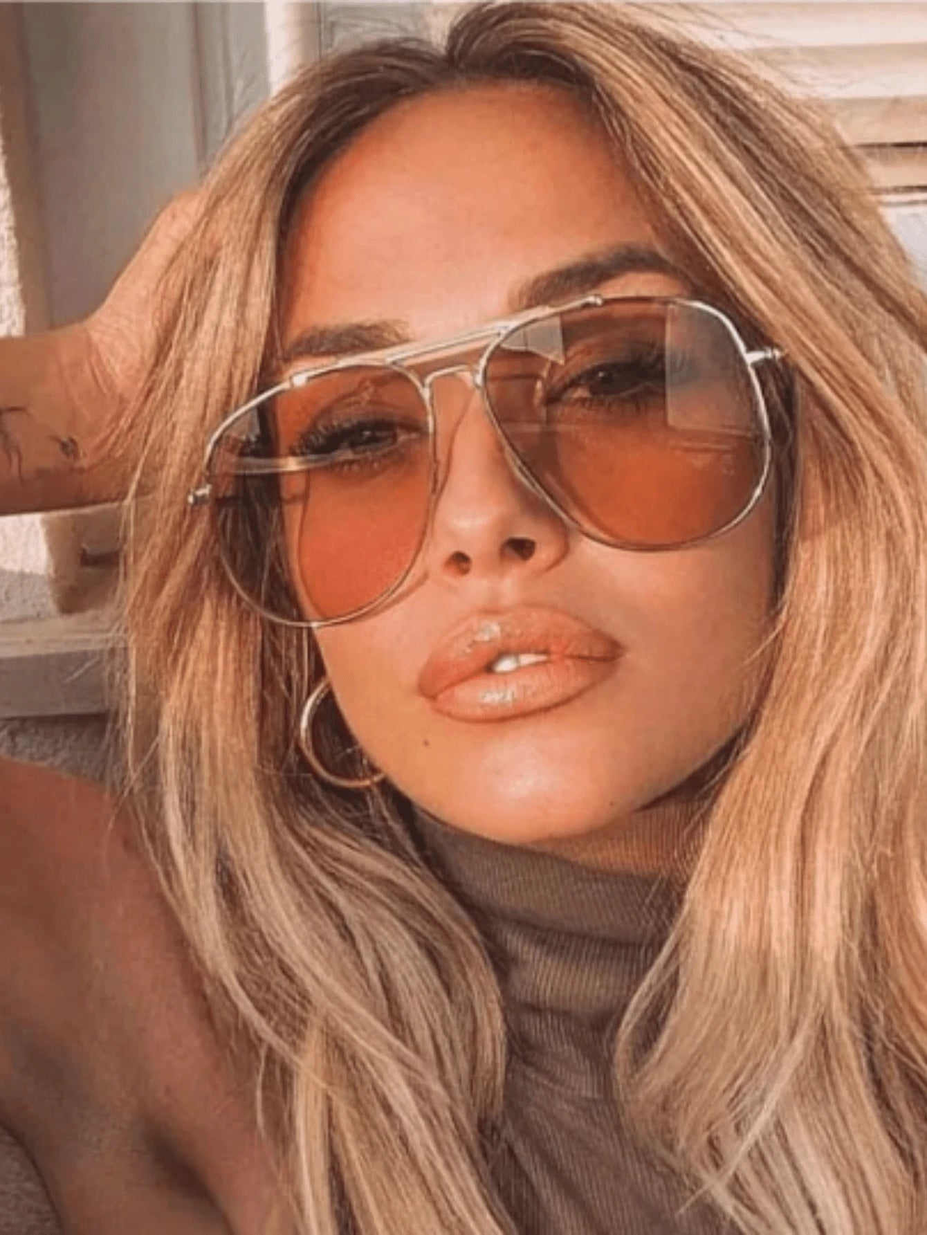 Woman wearing large sunglasses with a blurred background