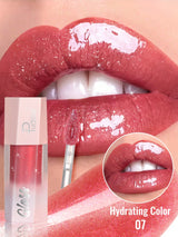 Lip gloss being applied to lips with close-up of color and product.