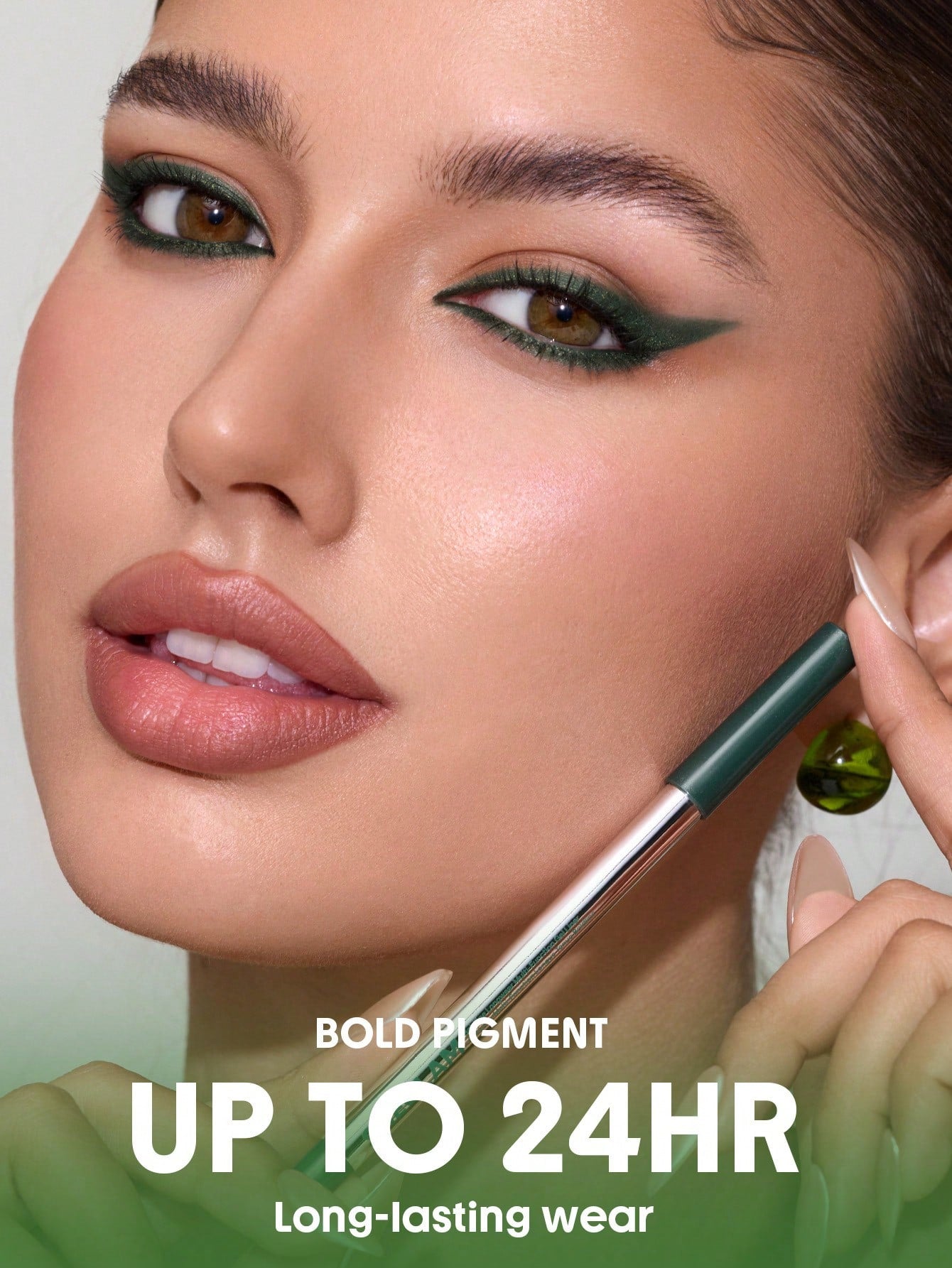 Woman applying makeup with a brush, focusing on long-lasting wear, on a light green background.