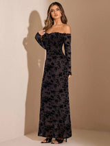 Woman wearing a black floral off-shoulder gown against a beige background