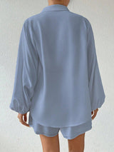 Person wearing a light blue pajama set against a white background