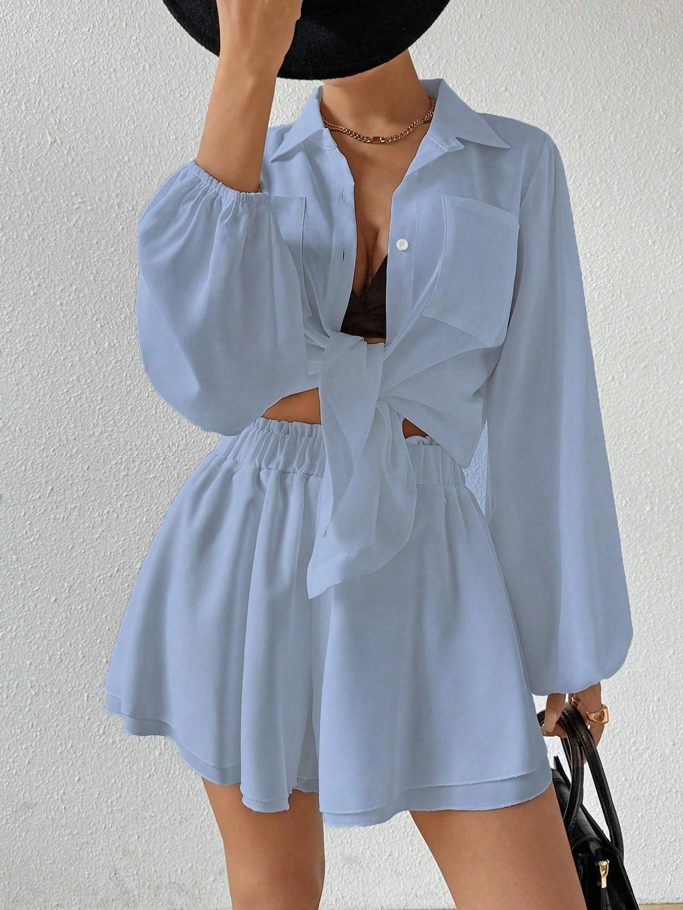 Light blue outfit with a matching top and shorts on a plain background