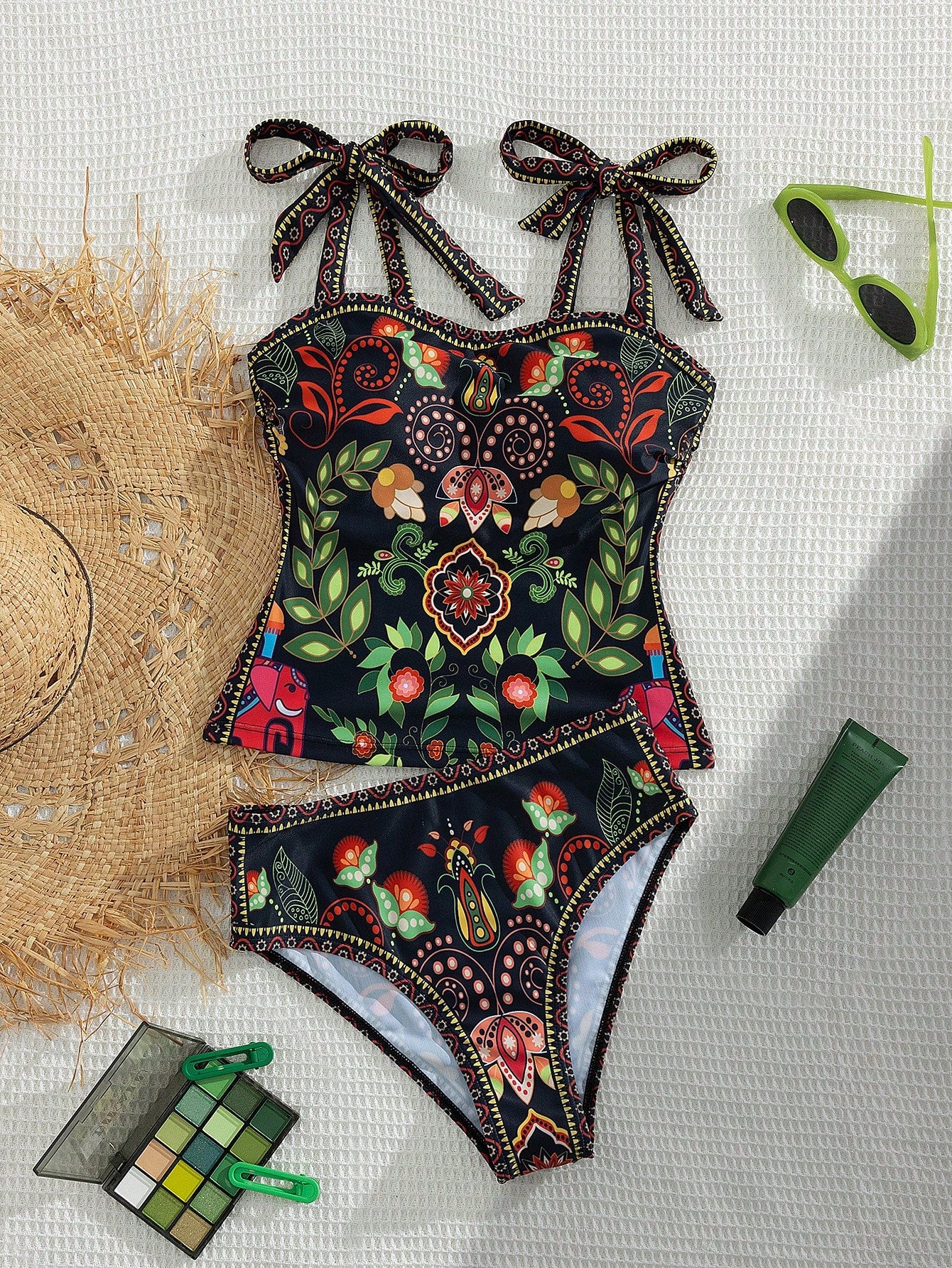 Colorful floral swimsuit with decorative elements on a textured surface.
