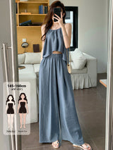 Woman taking a mirror selfie wearing a blue outfit in a living room.