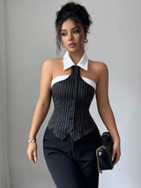 Woman wearing a black and white pinstripe top with a gray background