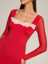 Red dress with lace detailing on a neutral background