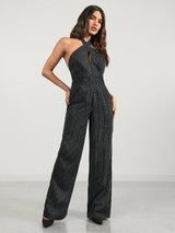 Woman wearing a black and white striped jumpsuit on a white background