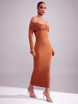 Woman wearing a brown off-shoulder dress against a gray background