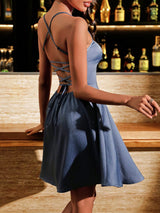Woman in a blue dress with a lace-up back in a bar setting