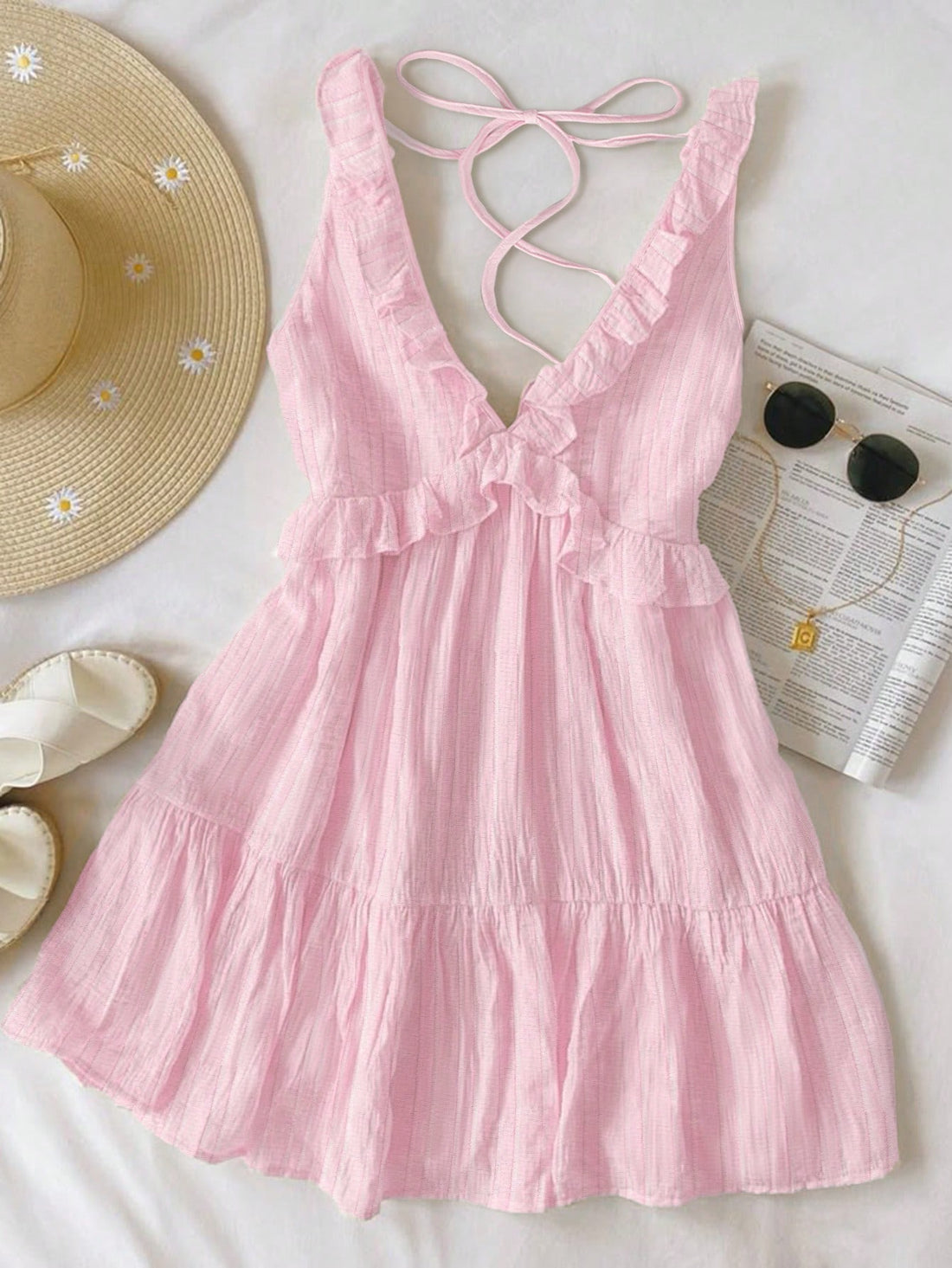 Pink dress with thin straps on a white background