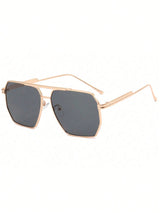 Sunglasses with rose gold frame and dark lenses on a white background