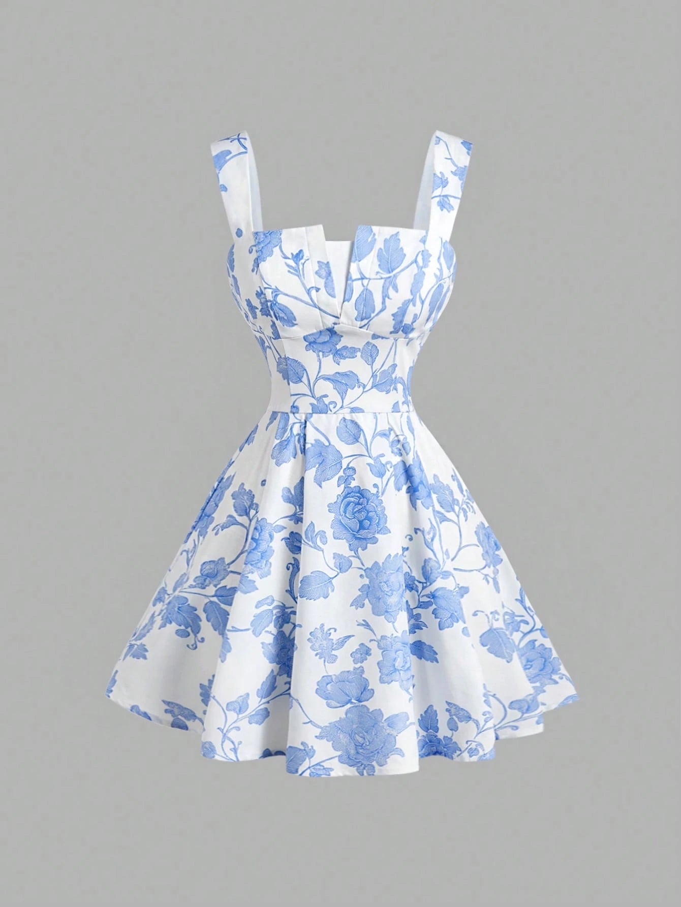 A sleeveless white dress with a blue floral toile pattern, featuring a sweetheart neckline, structured bodice, and a flared skirt, shown against a solid gray background.