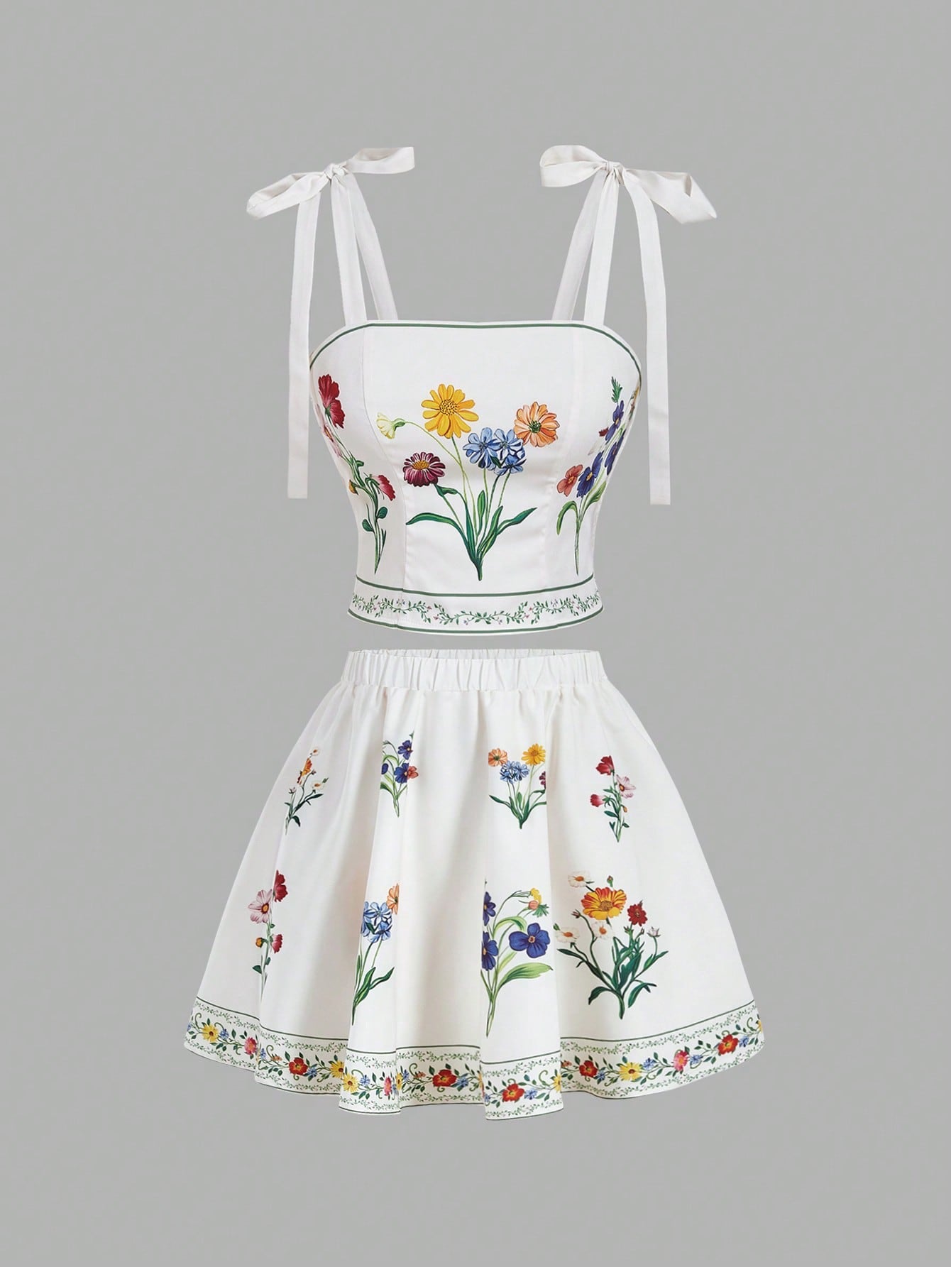 White two-piece outfit with floral embroidery on a gray background