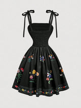 Black dress with floral embroidery on a white background
