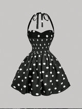 Black dress with white polka dots on a gray background