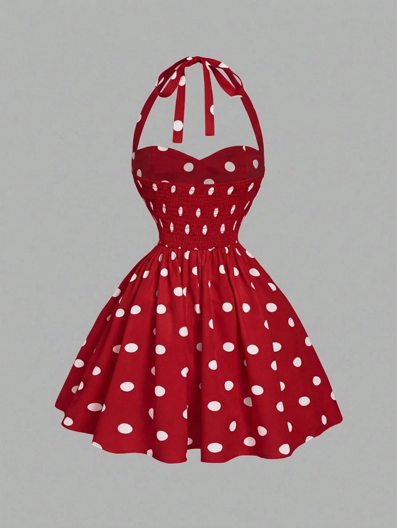 Red polka dot dress on a gray background