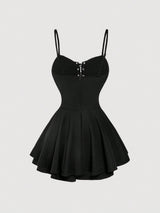 Black dress with thin straps on a light gray background