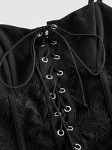 Black lace-up garment with detailed design on a white background