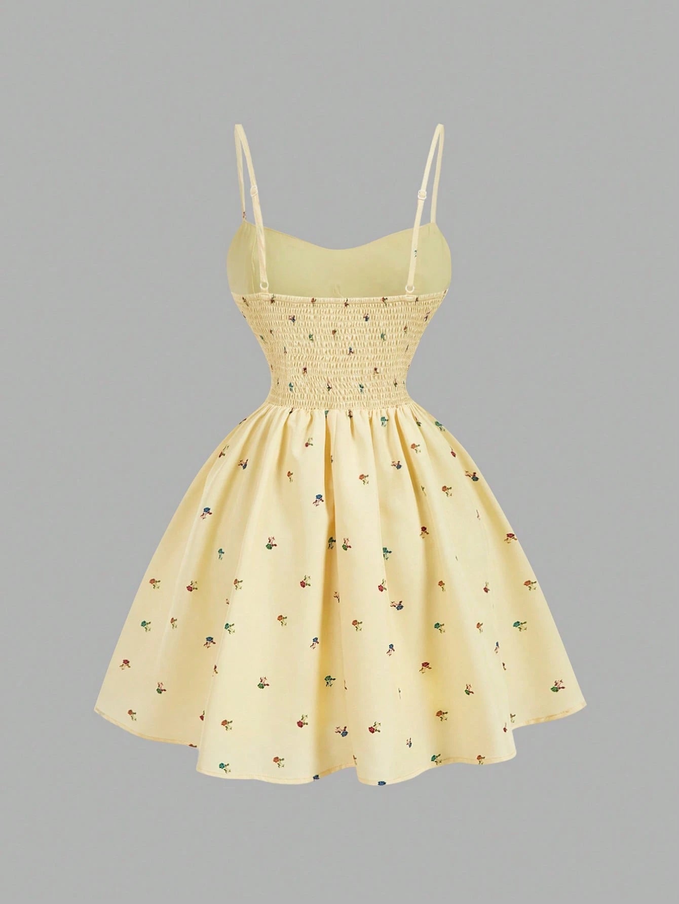 Yellow dress with floral pattern on a gray background