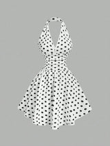 White dress with black polka dots on a gray background