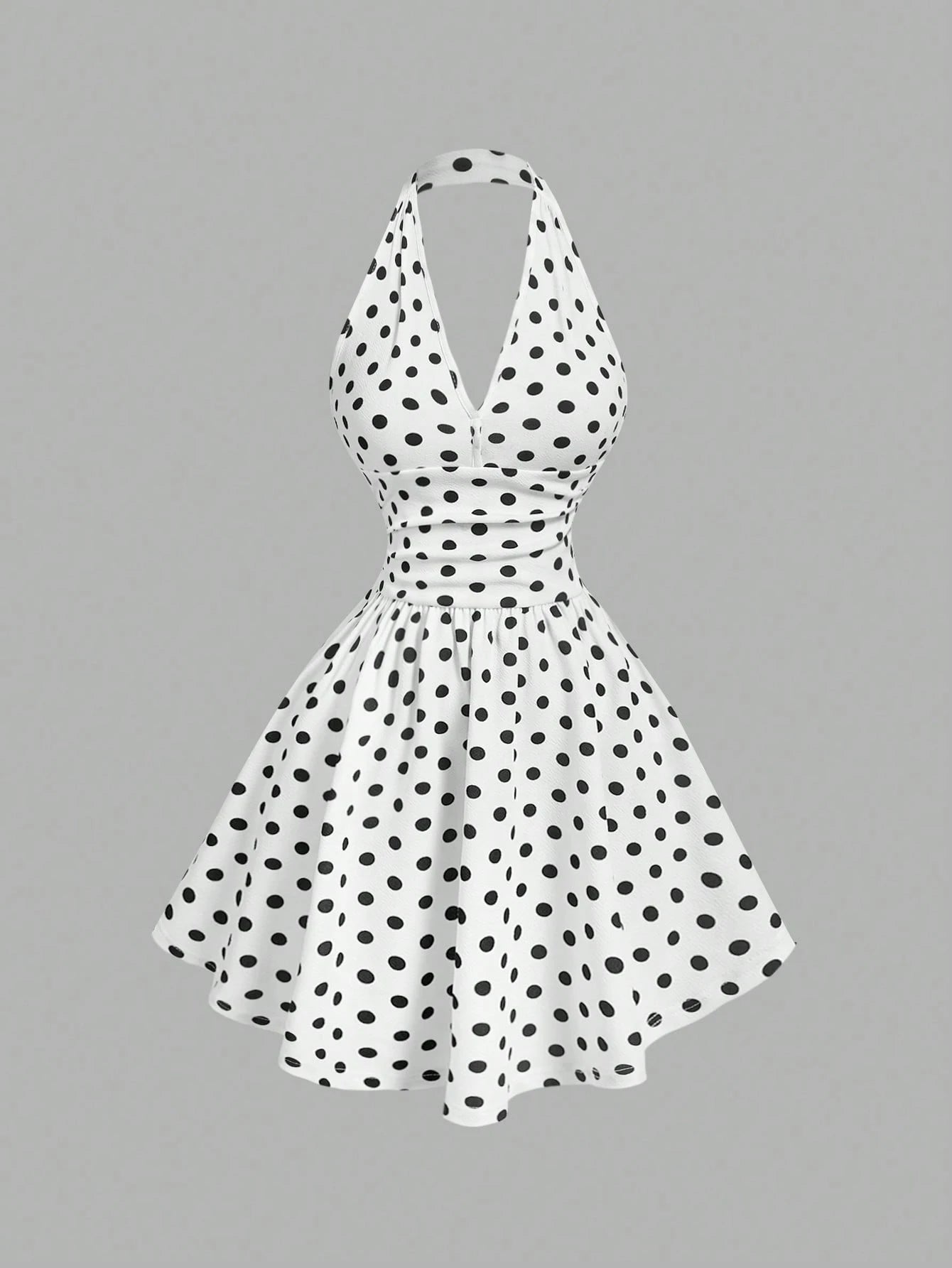 White dress with black polka dots on a gray background