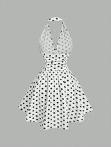 White dress with black polka dots on a gray background