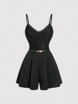 A black camisole romper with thin shoulder straps, a lace-trimmed V-neckline, a structured corset-style bodice, a slim waist belt, and short flared legs, shown on a plain light gray background.