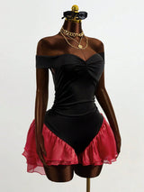 Mannequin wearing a black off-shoulder top and pink skirt with gold accessories on a white background