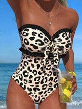 Person wearing a leopard print swimsuit on a beach