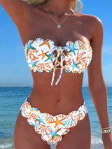 Woman wearing a colorful bikini with a beach background