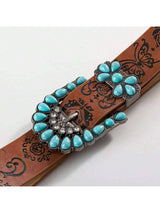 Belt with turquoise stone buckle on a white background