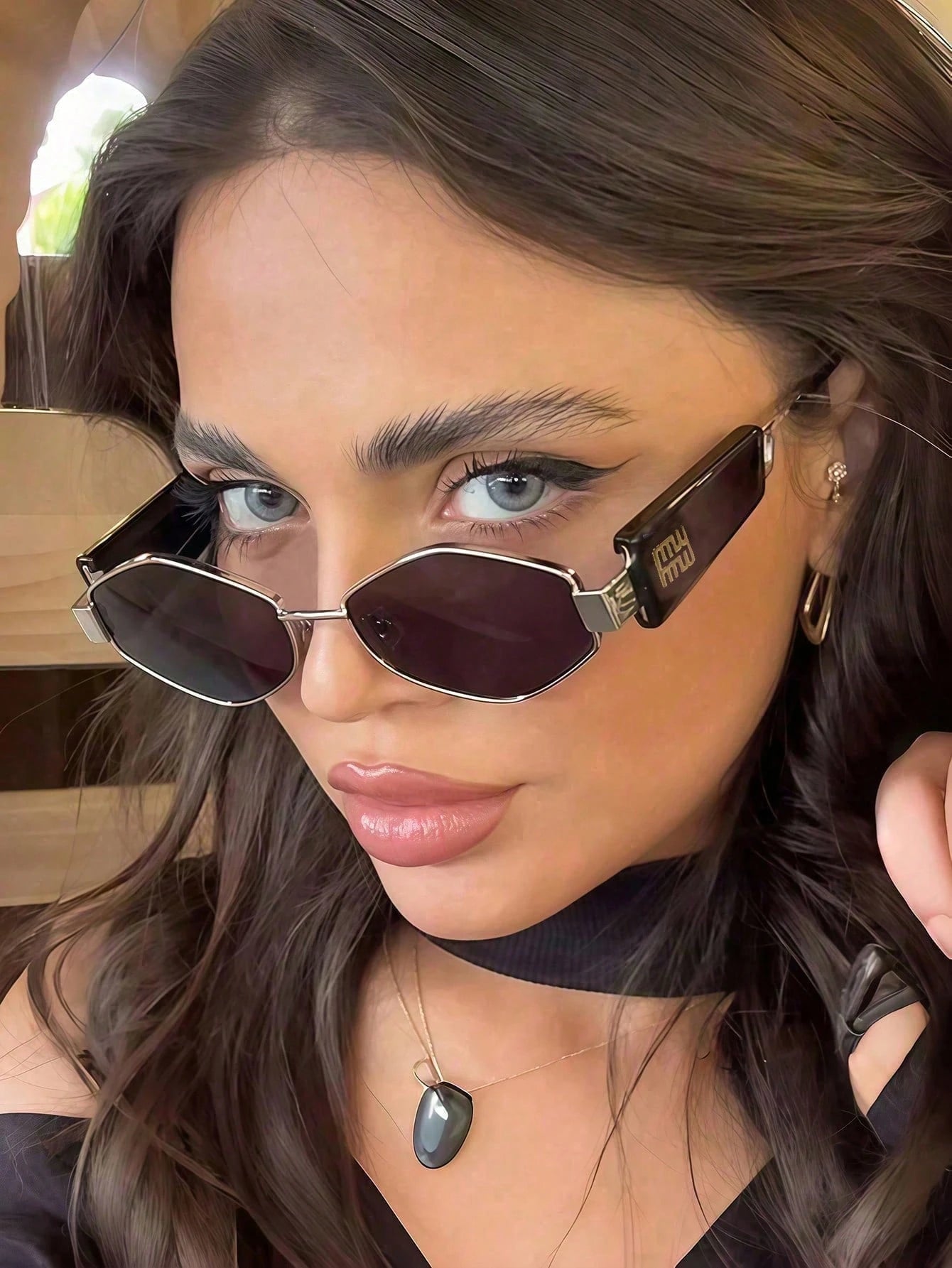 Close-up of a person wearing sunglasses with a blurred background
