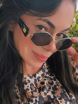 Woman wearing sunglasses with a leopard print pattern