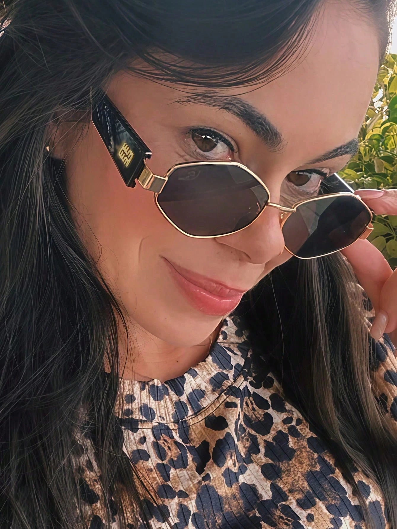 Woman wearing sunglasses with a leopard print pattern