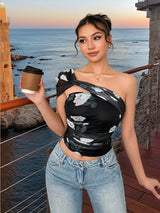 Woman holding a coffee cup by the ocean with a scenic background