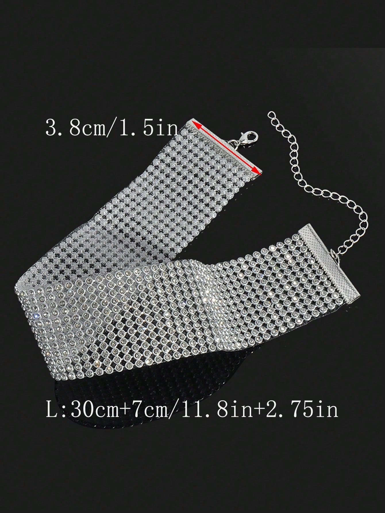 Silver mesh clutch bag with chain strap on a black background