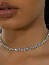 Close-up of a diamond necklace on a person's neck