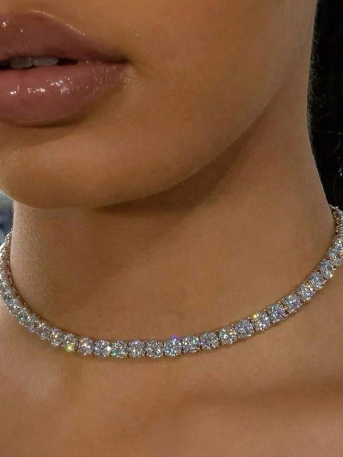 Close-up of a diamond necklace on a person's neck
