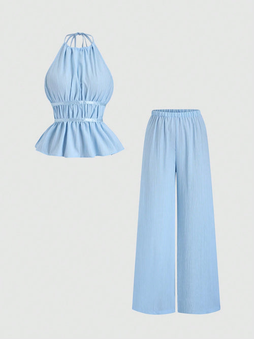 Light blue jumpsuit with halter top and wide-leg pants on a light gray background