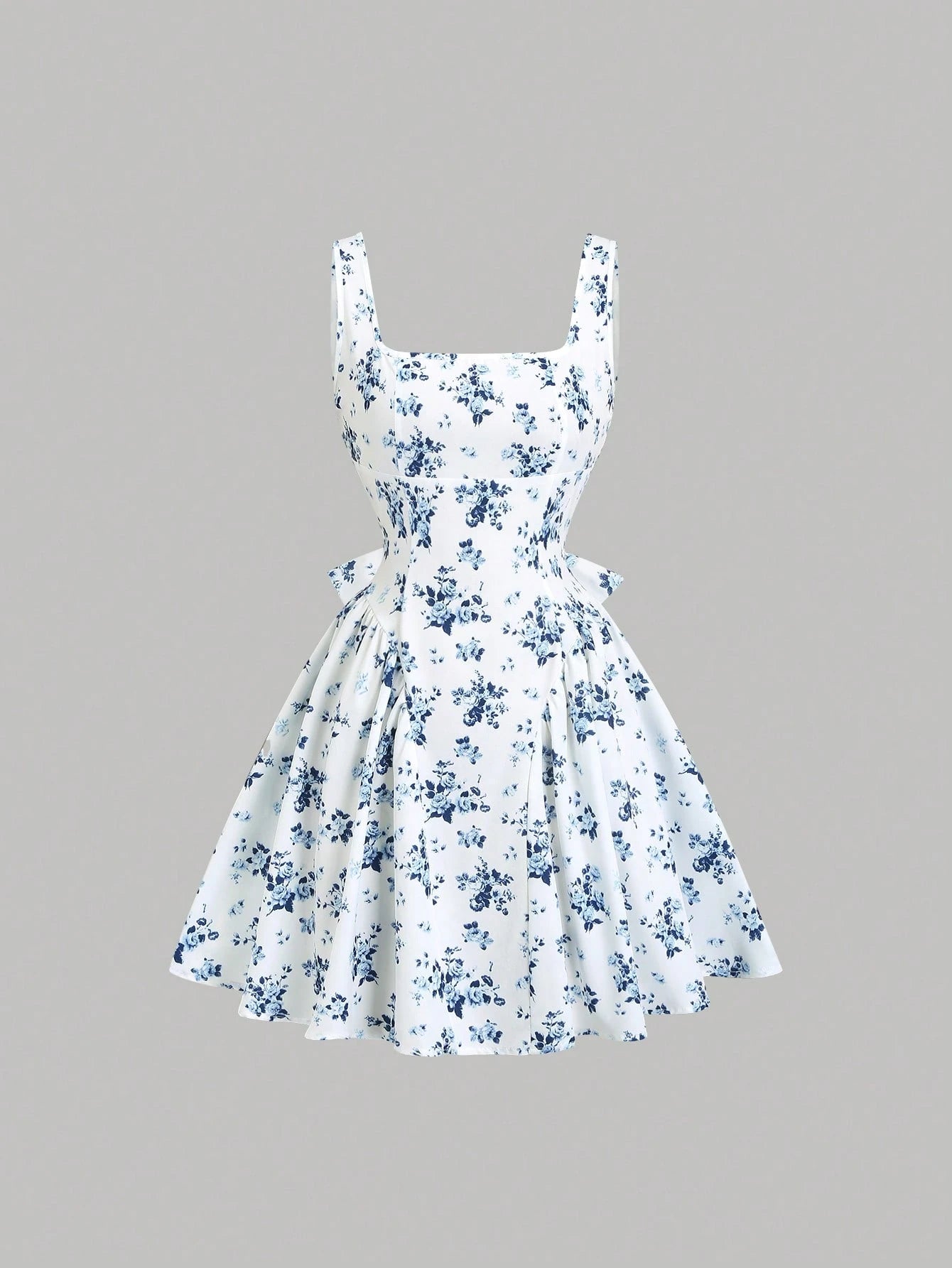 White dress with blue floral pattern on a gray background