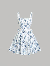White dress with blue floral pattern on a gray background