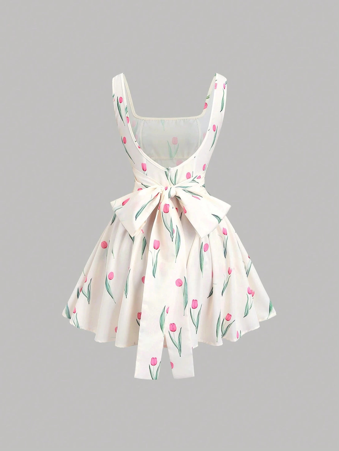 White dress with pink floral pattern on a gray background