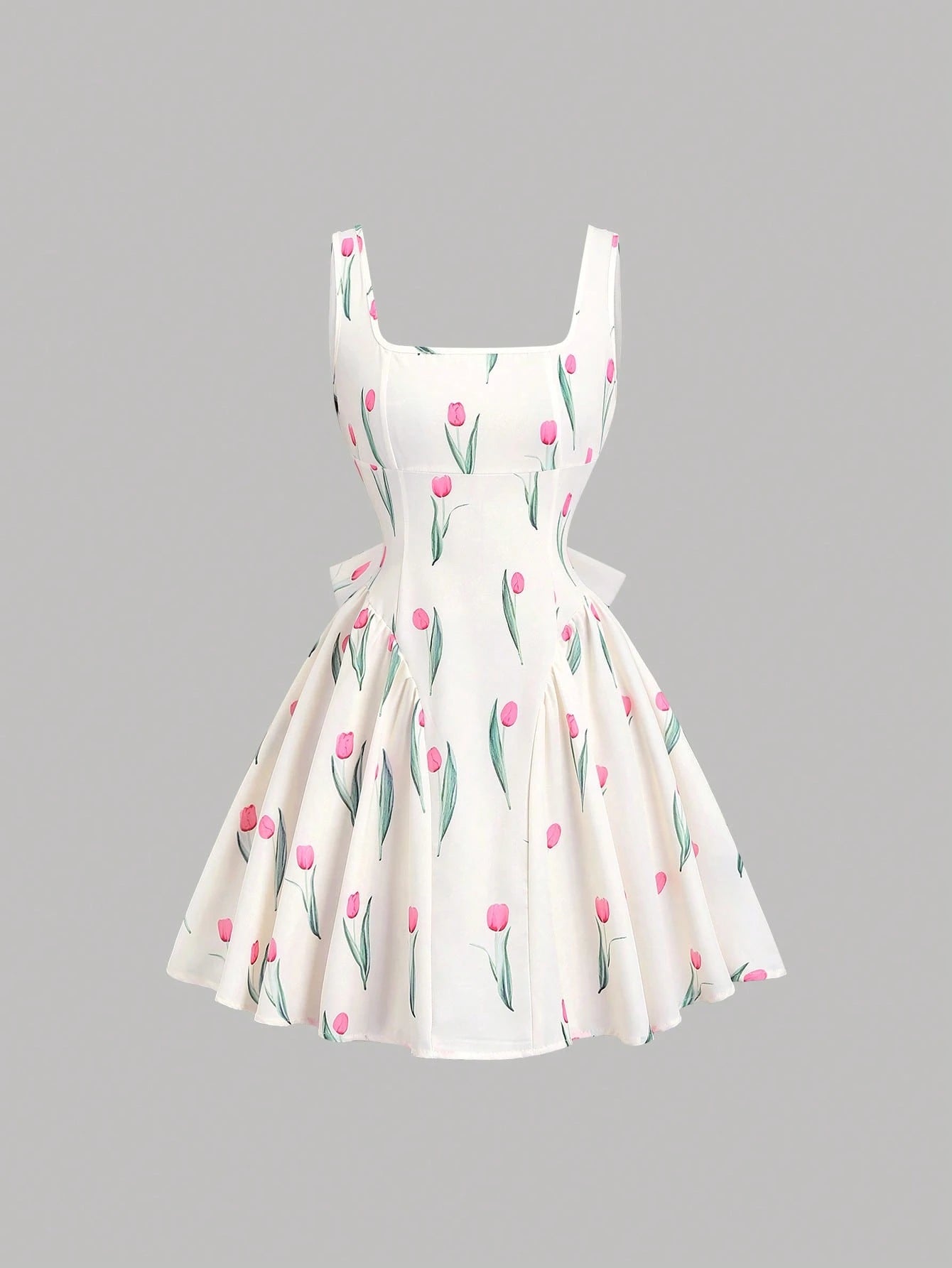 White dress with pink floral pattern on a gray background