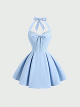 Light blue dress with a bow detail on a white background