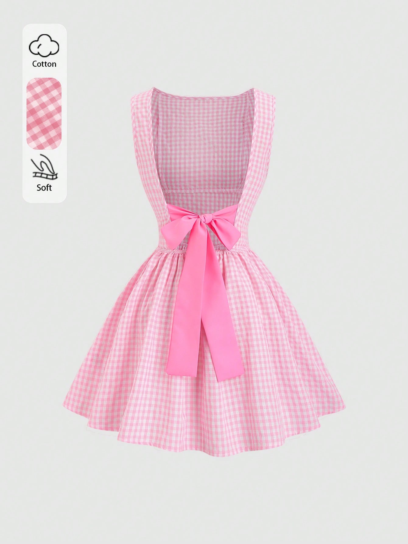 A pink and white gingham sleeveless dress with a large pink ribbon bow at the waist, shown on a light gray background with a small cotton and softness feature callout on the left.