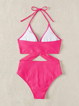 Pink bikini set with white top on a beige background