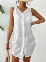 Woman wearing a white sleeveless button-up shirt against a white background