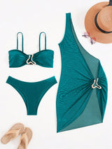 Teal bikini set and dress with a hat and sandals on a white background