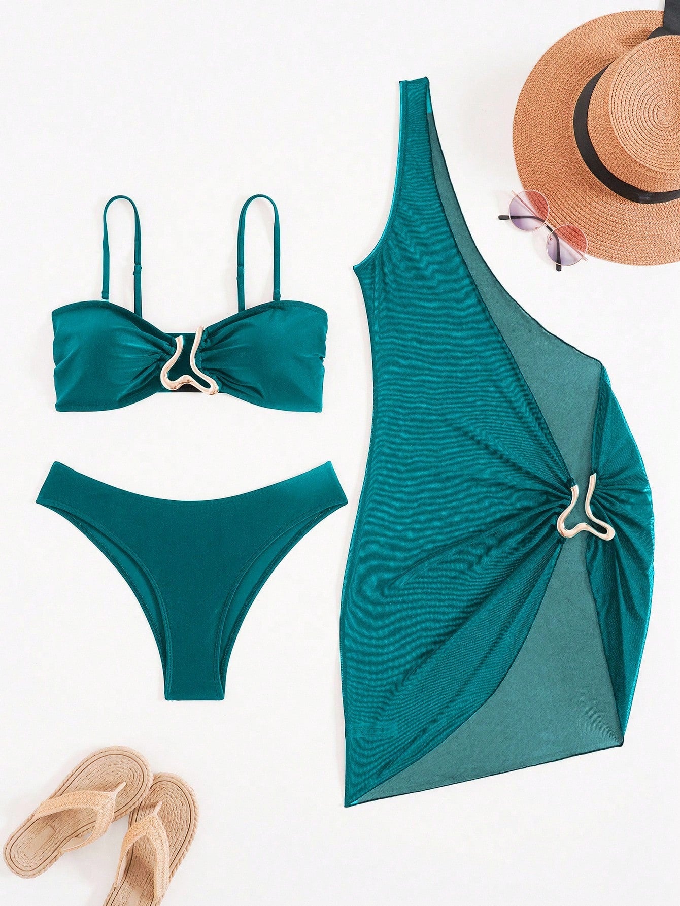 Teal bikini set and dress with a hat and sandals on a white background