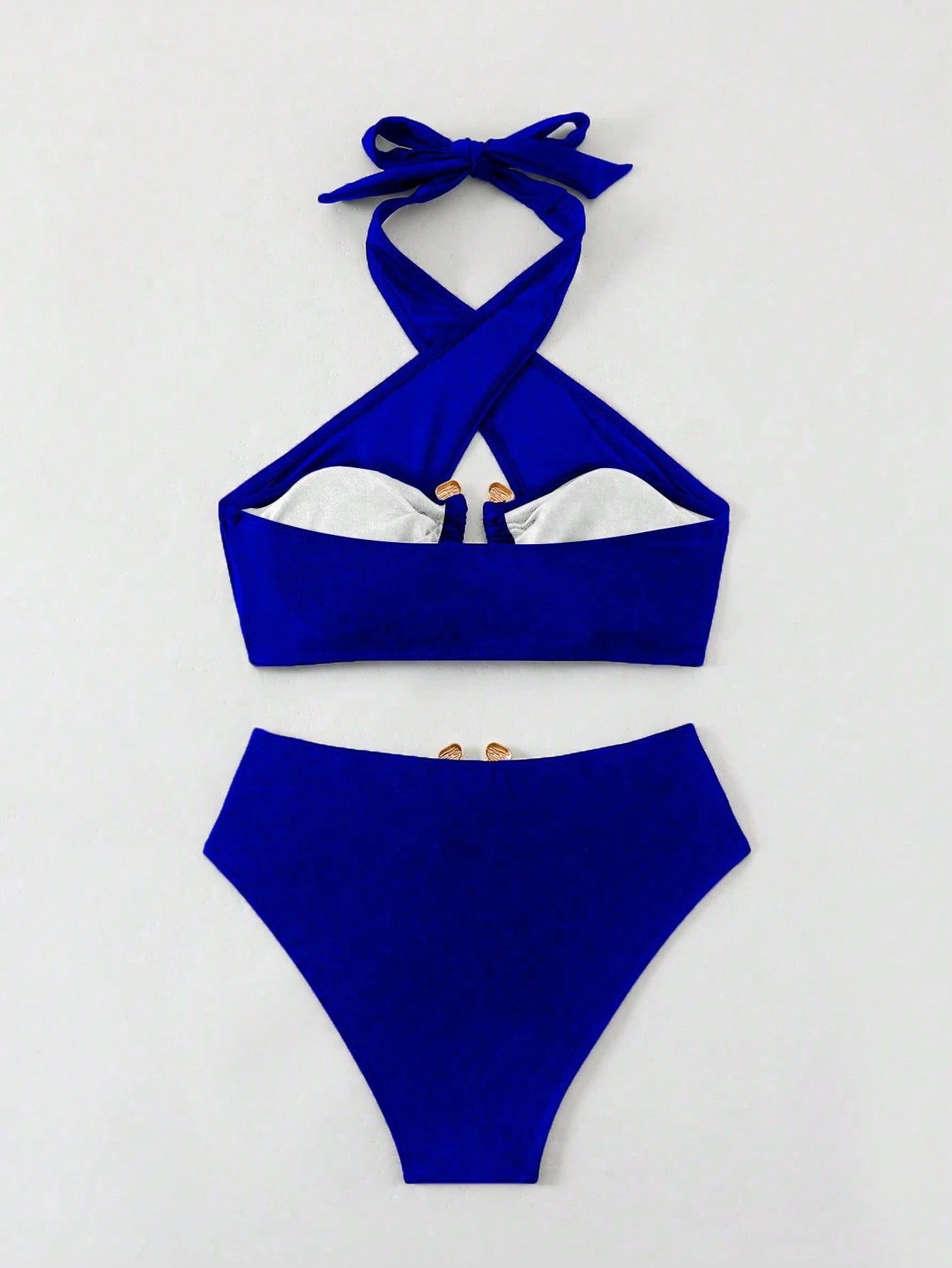 Blue bikini set with a white interior on a light gray background
